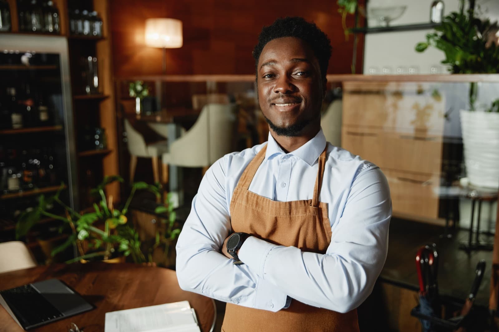 Restaurant professional standing inside a warm dining room