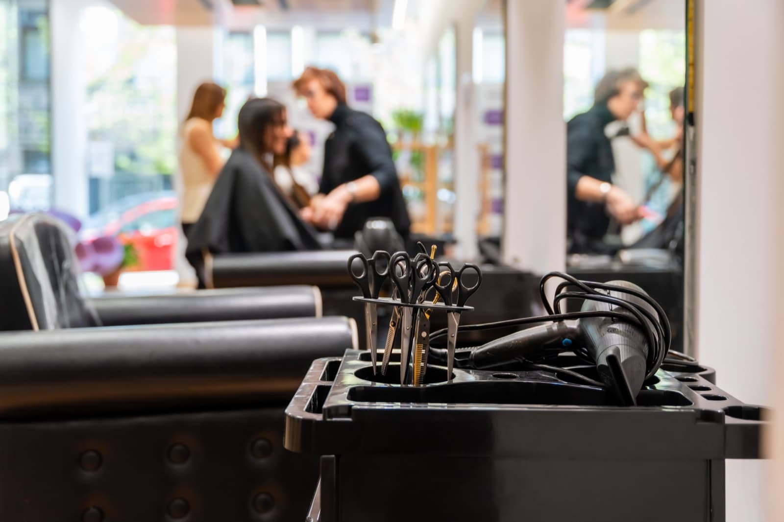 Professional scissors and hair dryers ready on a salon trolley