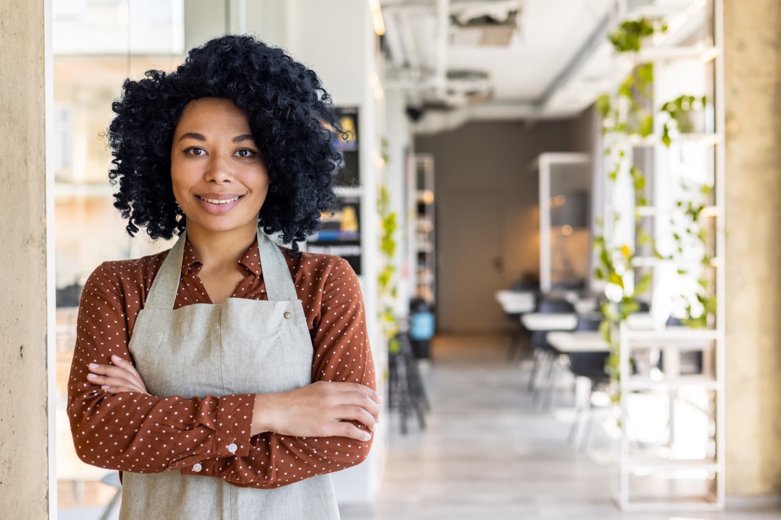 Restaurant owner standing inside a bright hospitality space
